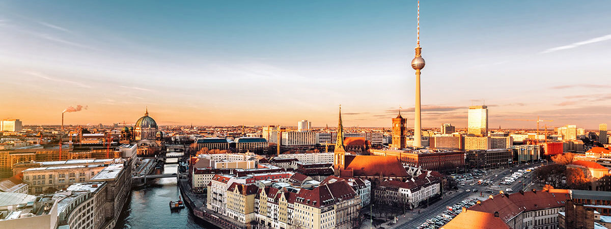 berlin cityscape with television tower under at sunset hour